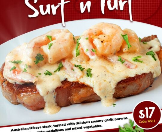 Surf 'n' Turf - Australian rib-eye steak, topped with delicious creamy garlic prawns. Served with potato medallions and mixed vegetables